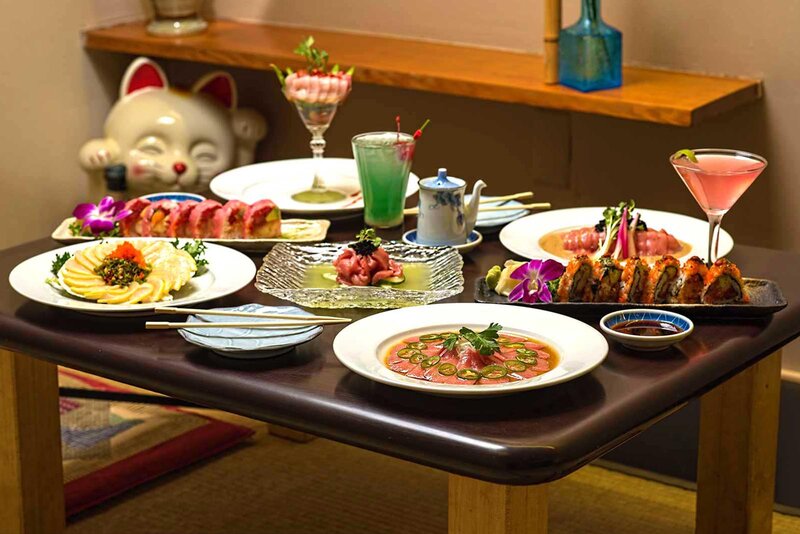 Many plated entrees on table with cocktails